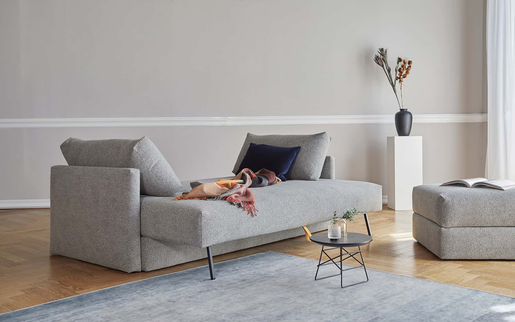 Cornila ottoman used as a chaise-style lounger extension